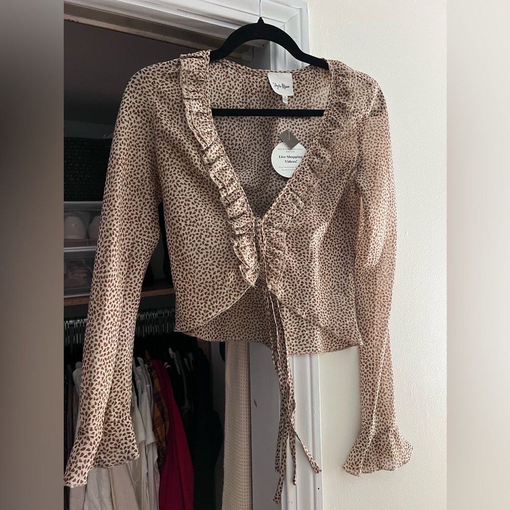 long sleeve cheetah print blouse. Ties in front.